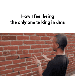 Man Talking to Someone in Front of Brick Wall