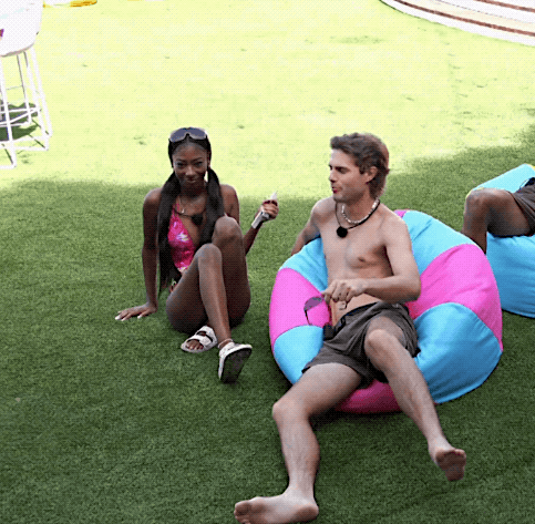 Man Talking to Woman on Pink and Blue Bean Bag Chair