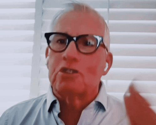 Man Talking With Glasses and Ear Buds