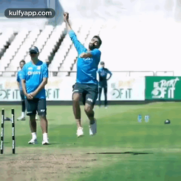 Man Throwing Ball in the Air on Field