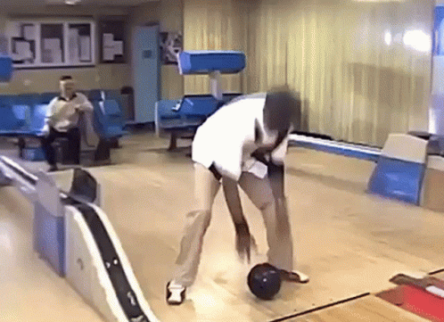 Man Throwing Bowling Ball on Bowling Alley