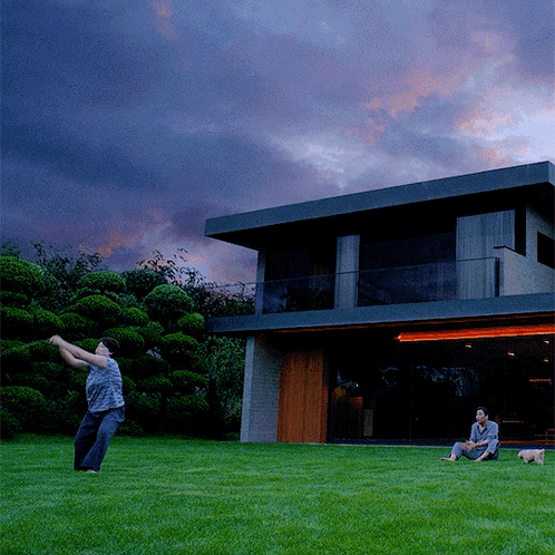 Man Throwing Frisbee In Front Of Large House GIF