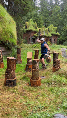 Man Throws Log in Field