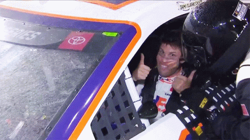 Man Thumbs Up in Race Car