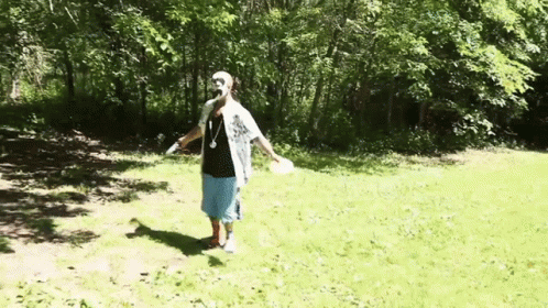 Man Tosses Frisbee GIF
