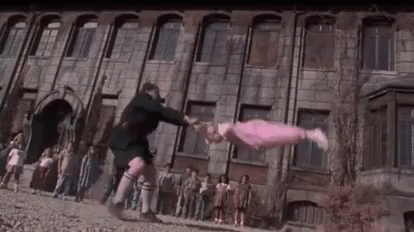 Man Tossing Girl in Front of Building