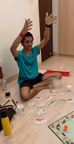 Man Tossing Monopoly Money While Sitting GIF
