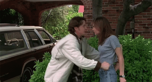 Man Touching Woman's Waist In Front Of Brown Jeep GIF