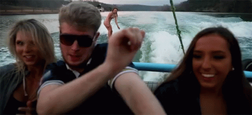 Man, Two Women on Boat, Background Woman