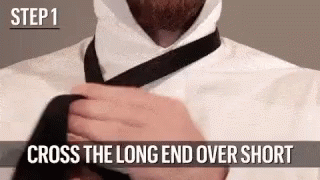Man Tying Tie Long End Over Short End
