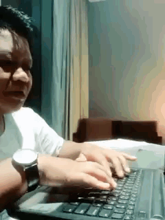 Man Typing on Laptop