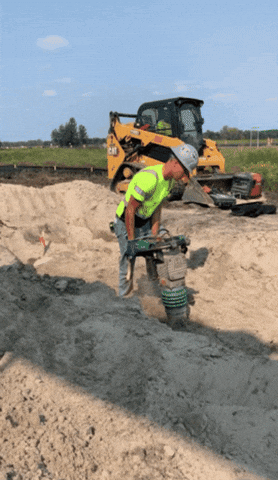Man Using A Jackhammer On The Ground GIF
