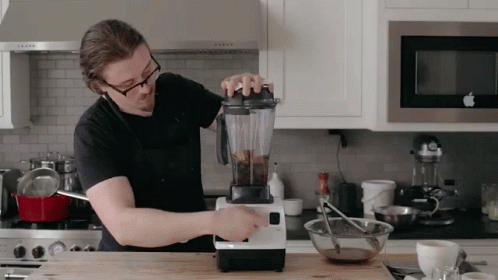 Man Using Blender in Kitchen