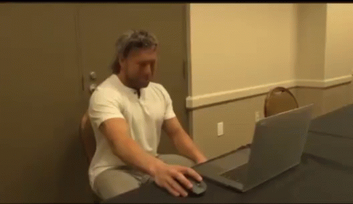 Man Using Laptop at Desk
