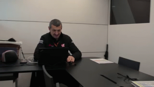 Man Using Laptop With Haas Shirt