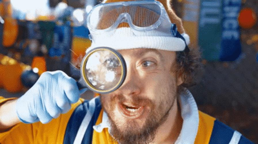 Man Using Magnifying Glass GIF