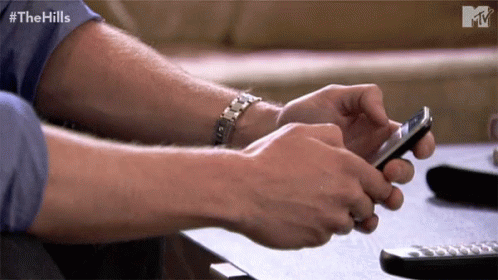 Man Using Smartphone with Hills Text