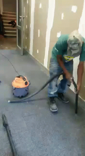 Man Using Vacuum Cleaner To Clean Floor GIF