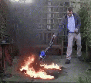 Man Using Vacuum Cleaner to Clear Fire