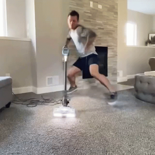 Man Vacuuming Living Room GIF