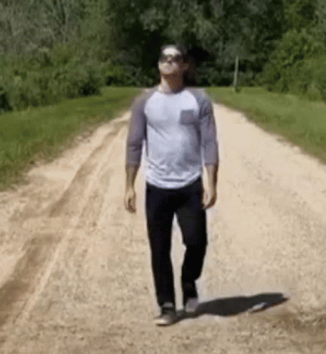 Man Walking Dirt Road with Sunglasses