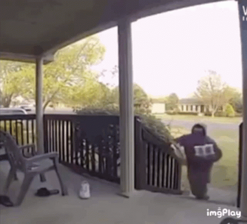 Man Walking Down Stairs Carrying Bag With Letter M GIF