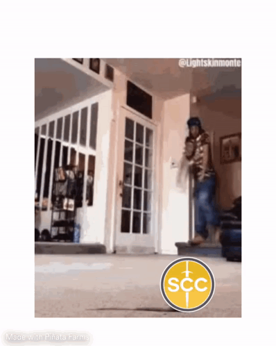 Man Walking Down Stairs with SCC Logo in Living Room