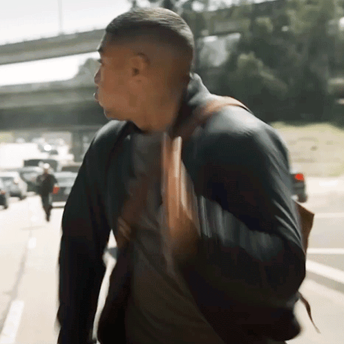 Man Walking Down Street With Backpack GIF