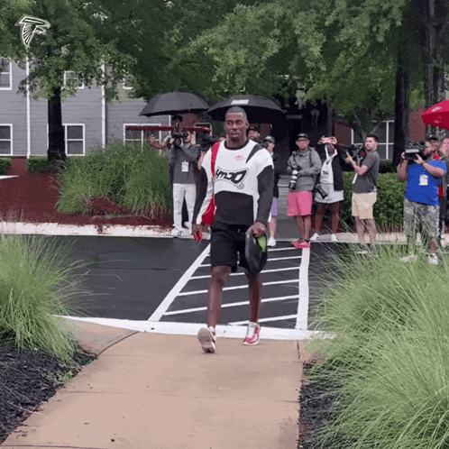 Man Walking In Falcons Shirt GIF
