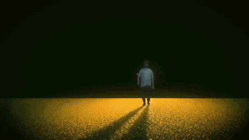 Man Walking in Field with Fire Explosion