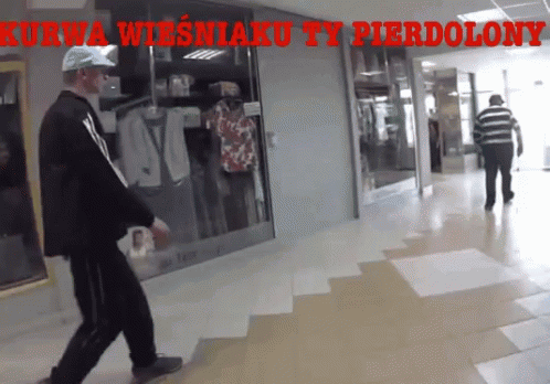 Man Walking In Hallway With Kurwa Wiesniaku Ty Pierdolony GIF