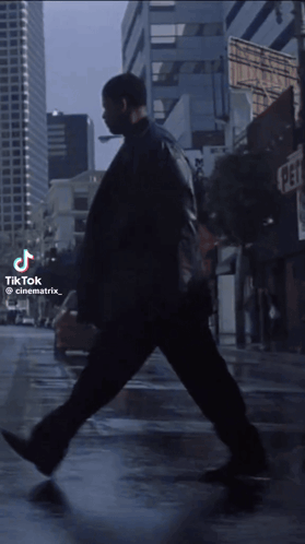 Man Walking on City Street With TikTok Watermark
