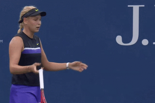 Man Walking Past Ford Ad on Tennis Court