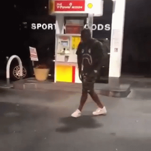 Man Walking Past Gas Pump Saying Sport Goods