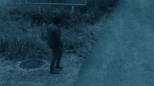 Man Walking Past Welcome to Silent Hill Sign
