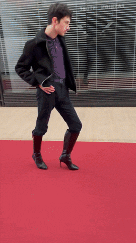 Man Walking Red Carpet in High Heels