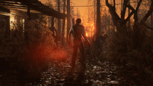 Man Walking Through Dark Forest With Torch