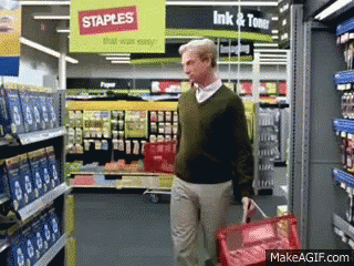 Man Walking Through Staples Store With Red Basket