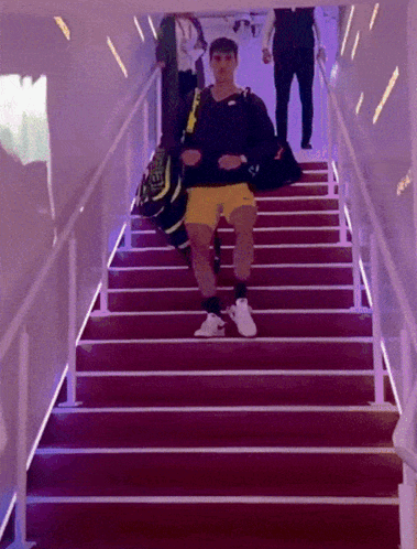 Man Walking Up Stairs With Nike Bag