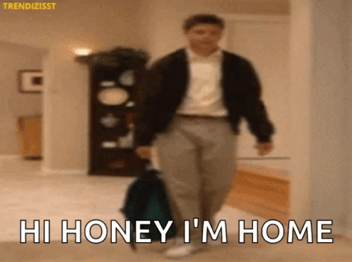 Man Walking With Suitcase Saying Hi Honey I'm Home