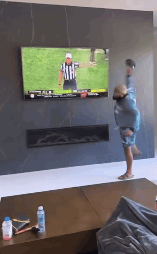 Man Watching Football on Television