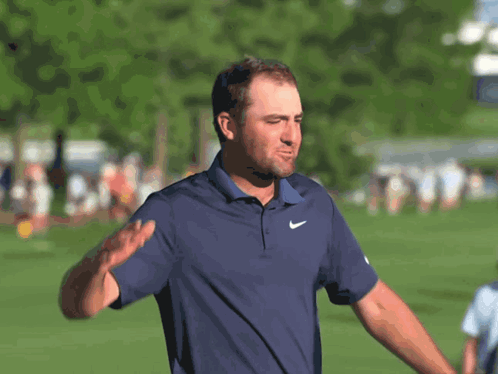 Man Waving In Blue Nike Shirt GIF