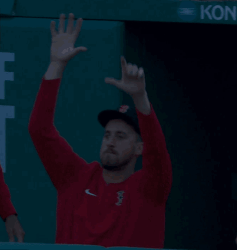 Man Waving in Red Sox Sweatshirt