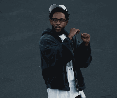 Man Waving in White Jacket and Pants