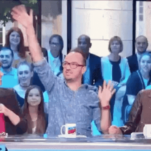 Man Waving to Crowd on TV Show