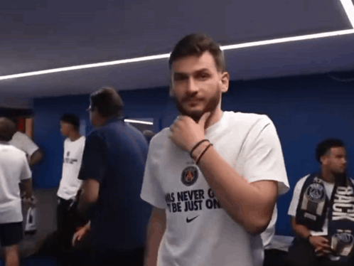 Man Wearing Als Never Can Be Just On Shirt Holding Chin GIF