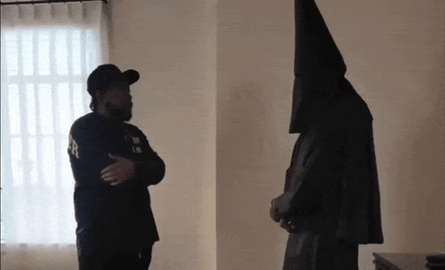 Man Wearing Black Hat with L