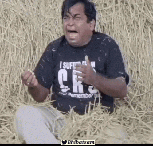Man Wearing Black Shirt Saying I Suffer From CRS Sitting in Hay