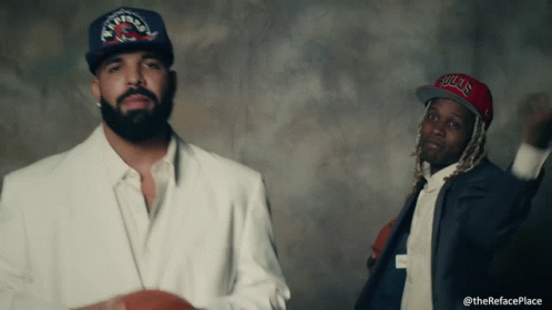 Man Wearing Bulls Hat Beside Another Man