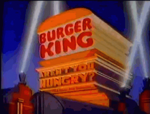 Man Wearing Burger King Crown Surrounded by Hamburgers